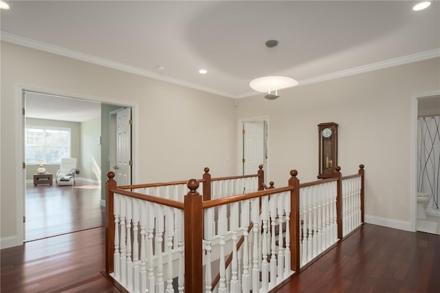 corridor with an upstairs landing, crown molding, wood finished floors, recessed lighting, and baseboards