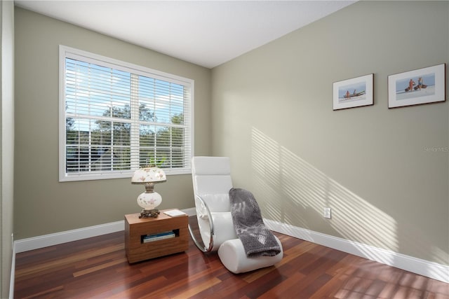 sitting room featuring baseboards and wood finished floors