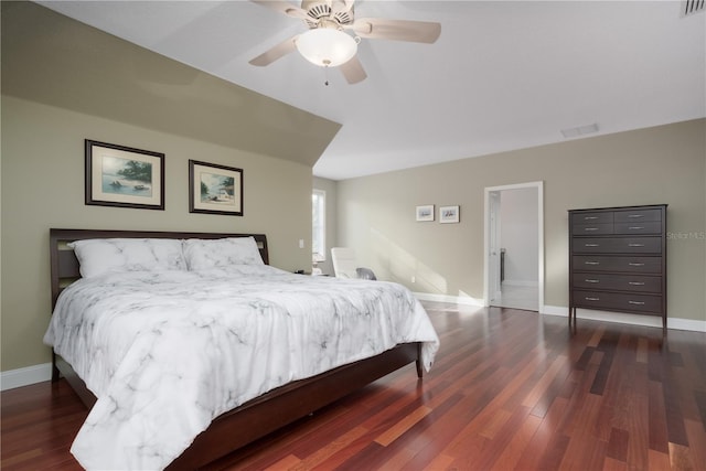 bedroom with baseboards, dark wood-type flooring, and a ceiling fan