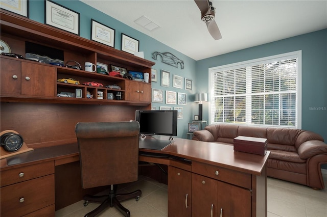 home office with built in study area, light tile patterned flooring, and a ceiling fan