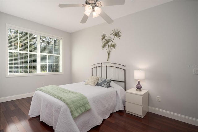 bedroom with baseboards, wood finished floors, and ceiling fan
