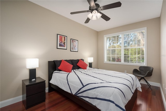 bedroom featuring baseboards, wood finished floors, and ceiling fan