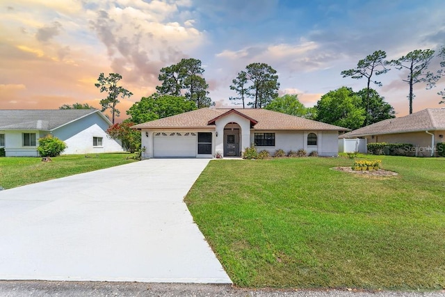 25 Westlawn Pl, Palm Coast, FL 32164 - view of front of house with a garage, stucco siding, a yard, and concrete driveway