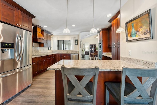 25 Westlawn Pl, Palm Coast, FL 32164 - kitchen with premium range hood, a peninsula, dark wood-style floors, stainless steel appliances, and recessed lighting