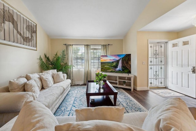 25 Westlawn Pl, Palm Coast, FL 32164 - living room featuring baseboards, vaulted ceiling, and wood finished floors