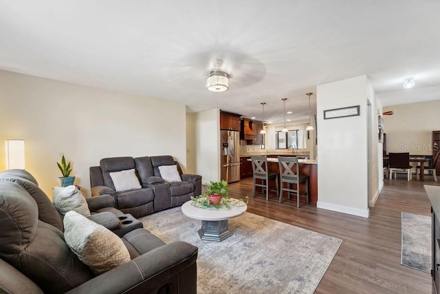 25 Westlawn Pl, Palm Coast, FL 32164 - living room featuring baseboards and dark wood finished floors