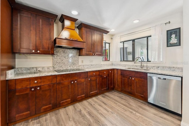 25 Westlawn Pl, Palm Coast, FL 32164 - kitchen with light stone countertops, premium range hood, light wood-type flooring, a sink, and dishwasher