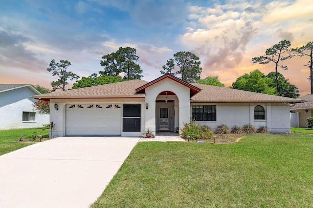 25 Westlawn Pl, Palm Coast, FL 32164 - mediterranean / spanish-style home featuring a garage, a yard, stucco siding, and driveway