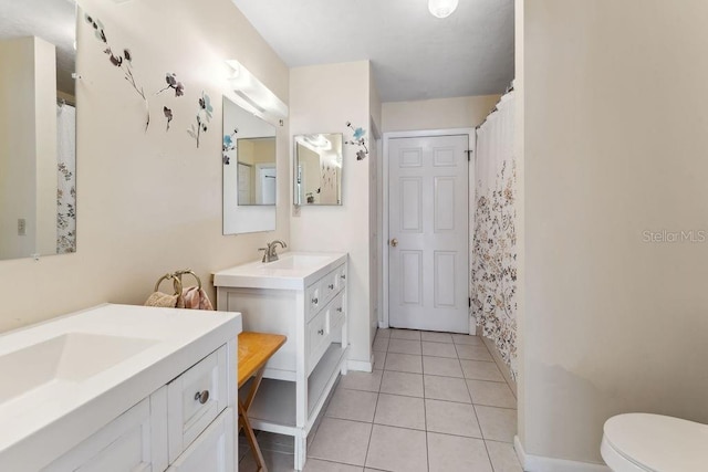 25 Westlawn Pl, Palm Coast, FL 32164 - full bath with a sink, toilet, tile patterned floors, baseboards, and two vanities
