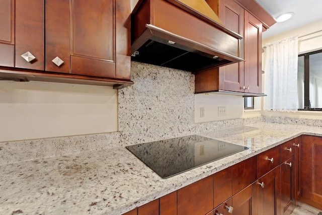 25 Westlawn Pl, Palm Coast, FL 32164 - kitchen featuring black electric cooktop, backsplash, under cabinet range hood, and light stone countertops
