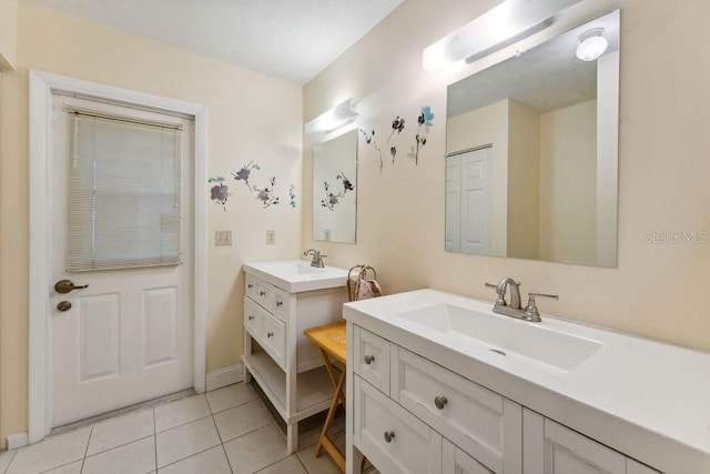 25 Westlawn Pl, Palm Coast, FL 32164 - bathroom featuring two vanities, a sink, and tile patterned flooring