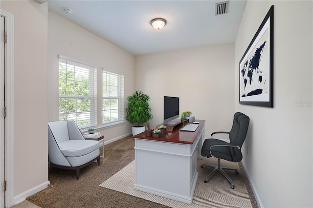 carpeted office space featuring baseboards