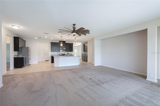 unfurnished living room with ceiling fan, light colored carpet, baseboards, recessed lighting, and light tile patterned flooring