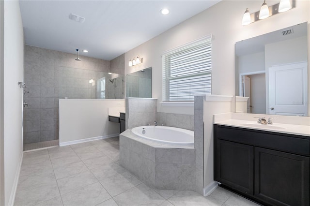 bathroom with a garden tub, vanity, tile patterned floors, and recessed lighting