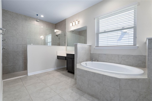 bathroom featuring vanity, tile patterned floors, a bath, and walk in shower