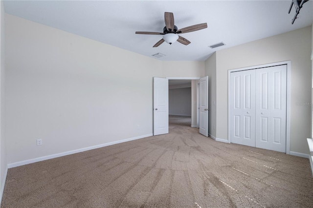 unfurnished bedroom with carpet, baseboards, a closet, and ceiling fan