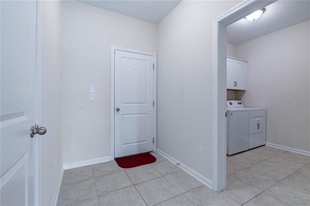 laundry room with washer and dryer, cabinet space, light tile patterned floors, and baseboards
