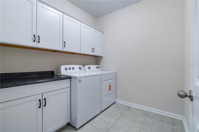 laundry room with washing machine and clothes dryer, cabinet space, baseboards, and light tile patterned flooring