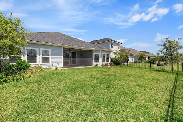 rear view of house with a sunroom and ceiling fan