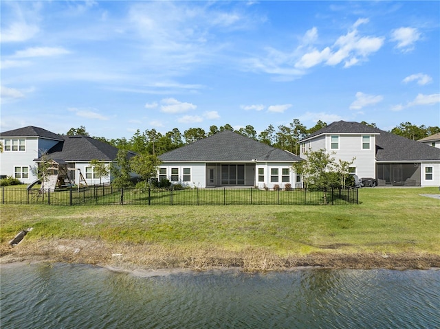 rear view of house featuring a water view and a sunroom