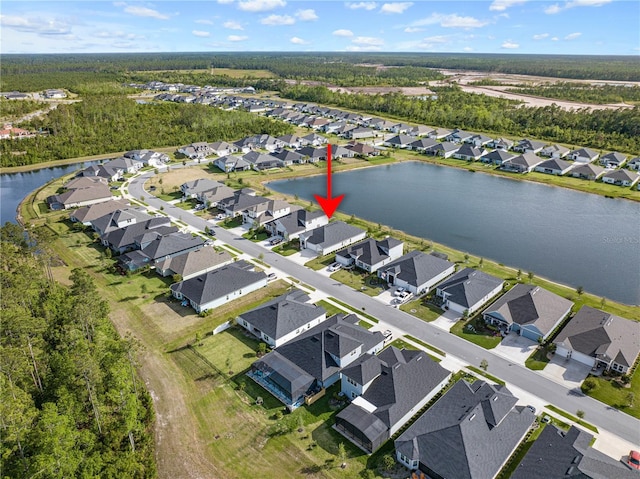 view of property location featuring a large body of water and nearby suburban area