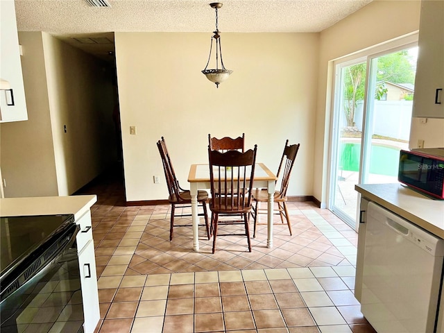 dining area featuring light tile patterned floors, baseboards, and a textured ceiling