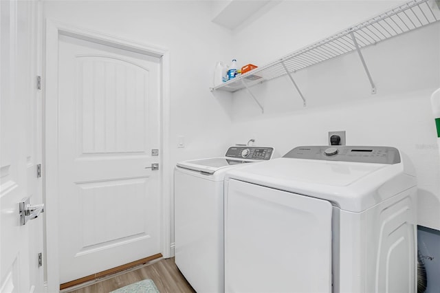 laundry room featuring washer and clothes dryer, laundry area, and light wood-style flooring