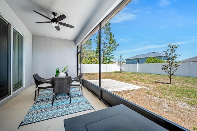 sunroom featuring a ceiling fan