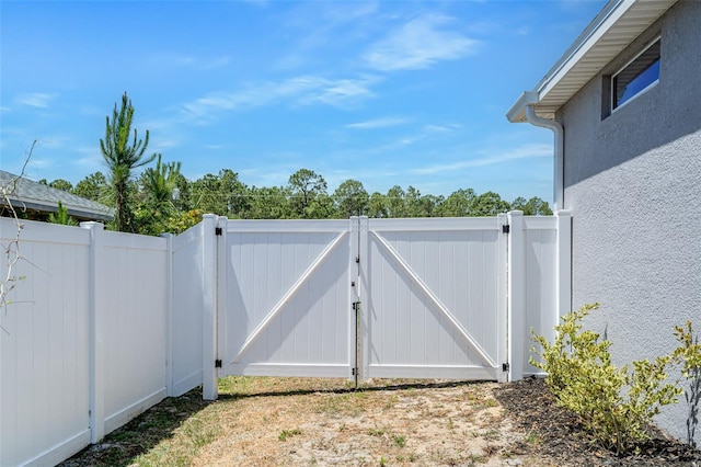 view of gate with fence
