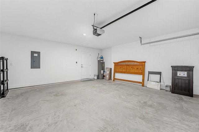 garage featuring electric panel, water heater, and a garage door opener