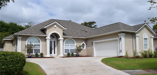348 Palmas Cir, Saint Augustine, FL 32086 - ranch-style house with a garage, a shingled roof, stucco siding, and concrete driveway