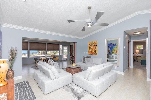 living room featuring crown molding, baseboards, and lofted ceiling