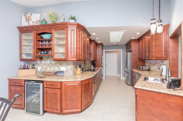 kitchen featuring decorative backsplash, appliances with stainless steel finishes, a sink, light stone counters, and wine cooler