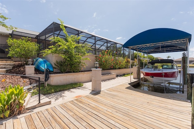 view of dock with boat lift and glass enclosure