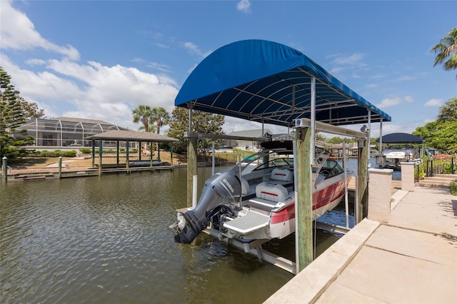dock area with boat lift and a water view