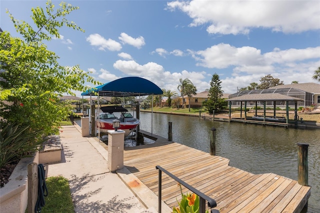 dock area featuring boat lift and a water view