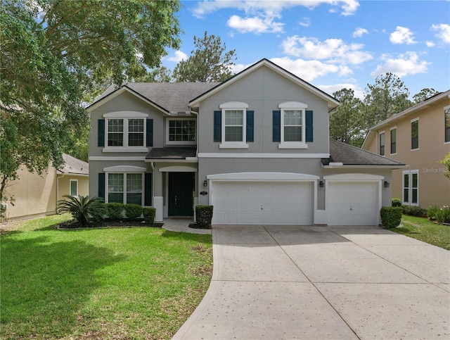 traditional home with a shingled roof, a front lawn, a garage, stucco siding, and driveway