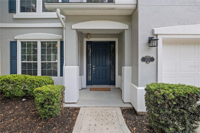 view of exterior entry with stucco siding
