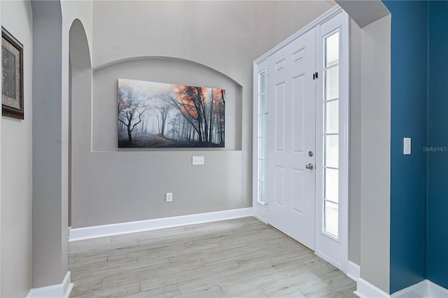 entrance foyer featuring baseboards and wood finished floors
