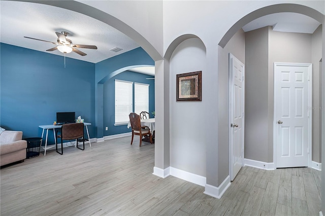 interior space with baseboards, visible vents, and light wood-style floors