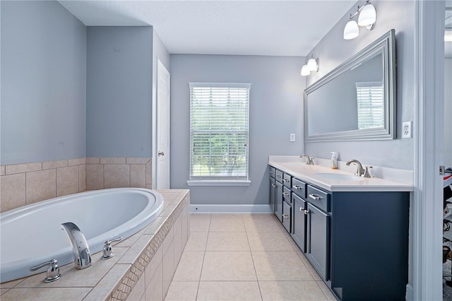 full bathroom featuring double vanity, baseboards, a sink, and a garden tub