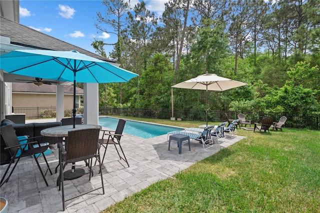view of swimming pool with a lawn, a fenced in pool, a fenced backyard, an outdoor fire pit, and a patio
