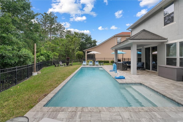 view of pool with outdoor lounge area, a fenced backyard, a fenced in pool, a patio area, and a lawn
