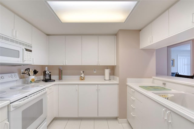 2937 S Atlantic Ave Unit 2001, Daytona Beach, FL 32118 - kitchen with white appliances, light countertops, light tile patterned floors, and white cabinets