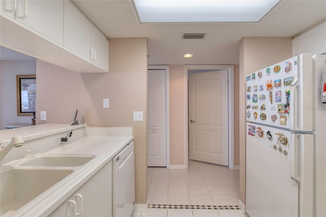 2937 S Atlantic Ave Unit 2001, Daytona Beach, FL 32118 - kitchen featuring a sink, white appliances, visible vents, light tile patterned floors, and baseboards