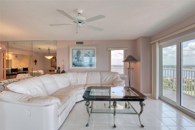 2937 S Atlantic Ave Unit 2001, Daytona Beach, FL 32118 - living area featuring a textured ceiling, a ceiling fan, visible vents, and light tile patterned flooring