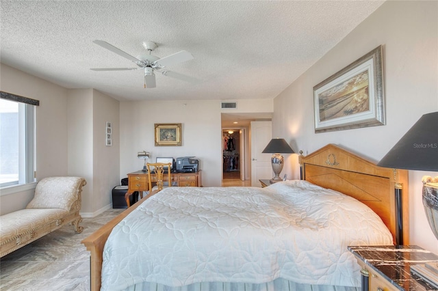 2937 S Atlantic Ave Unit 2001, Daytona Beach, FL 32118 - bedroom with a textured ceiling, visible vents, a spacious closet, a ceiling fan, and baseboards