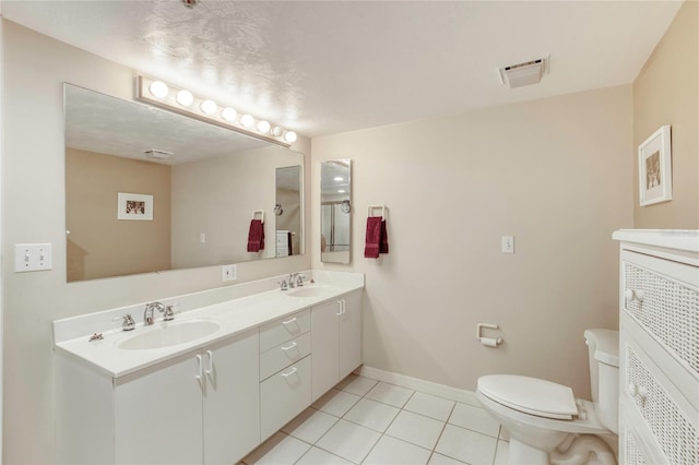 2937 S Atlantic Ave Unit 2001, Daytona Beach, FL 32118 - bathroom with a sink, double vanity, toilet, and tile patterned flooring