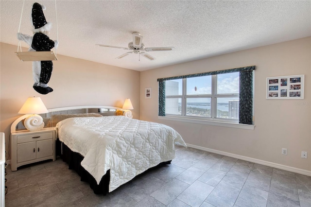 2937 S Atlantic Ave Unit 2001, Daytona Beach, FL 32118 - bedroom with a textured ceiling, baseboards, and a ceiling fan