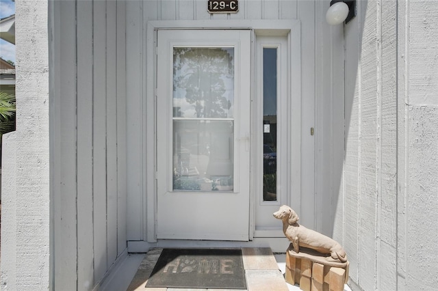 doorway to property featuring board and batten siding